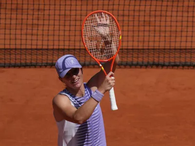 Iga Swiatek of Poland celebrates winning against Emerson Jones of Australia during their first round women's singles tennis match at the French Open tennis tournament in Paris, Monday, May 25, 2026. (AP Photo/Thibault Camus)