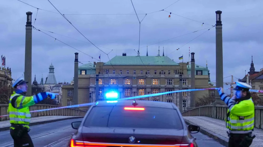 Police officers guard a street in downtown Prague, Czech Republic, Thursday, Dec. 21, 2023. Czech police say a shooting in downtown Prague has killed an unspecified number of people and wounded others. (AP Photo/Petr David Josek)