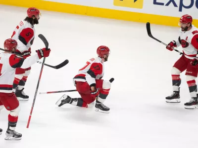 Carolina Hurricanes' Andrei Svechnikov (37) celebrates with teammates Jaccob Slavin (74), Jalen Chatfield (5) and Jordan Martinook (48) after his goal during overtime of Game 3 of the Eastern Conference finals NHL hockey Stanley Cup playoff series against the Montreal Canadiens in Montreal, Monday, May 25, 2026. (Christinne Muschi/The Canadian Press via AP) CORRECTION: Corrected the goal scorer to Andrei Svechnikov