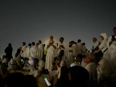 Muslim pilgrims pray at top of the rocky hill known as the Mountain of Mercy, on the Plain of Arafat, during the annual Hajj pilgrimage near the holy city of Mecca, Saudi Arabia, Tuesday, May 26, 2026. (AP Photo/Altaf Qadri)