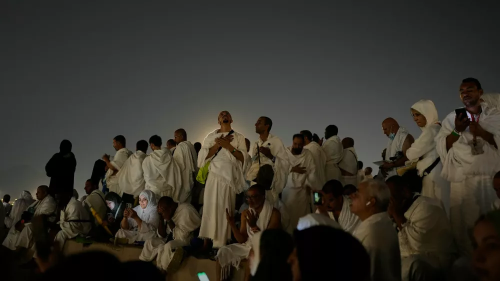 Muslim pilgrims pray at top of the rocky hill known as the Mountain of Mercy, on the Plain of Arafat, during the annual Hajj pilgrimage near the holy city of Mecca, Saudi Arabia, Tuesday, May 26, 2026. (AP Photo/Altaf Qadri)