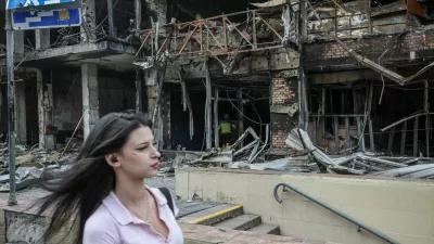 A woman walks along a ruined market, which was hit during yesterday's Russian missile and drone attack, amid Russia's attack on Ukraine, in Kyiv, Ukraine, May 25, 2026. REUTERS/Alina Smutko