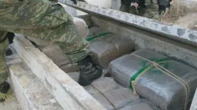 Soldiers remove a tombstone to display marijuana packages in this July 26, 2012 handout photograph released to Reuters on July 28. The Army located 241 packages of marijuana, weighing more than two tons, hidden in cemetery tombstones in the city of Camargo, in the Mexican state of Tamaulipas, according to the Defence Minister (SEDENA) statement. Picture taken July 26, 2012. REUTERS/Sedena/Handout (MEXICO - Tags: MILITARY DRUGS SOCIETY) FOR EDITORIAL USE ONLY. NOT FOR SALE FOR MARKETING OR ADVERTISING CAMPAIGNS. THIS IMAGE HAS BEEN SUPPLIED BY A THIRD PARTY. IT IS DISTRIBUTED, EXACTLY AS RECEIVED BY REUTERS, AS A SERVICE TO CLIENTS