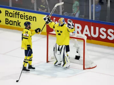 Ice Hockey - IIHF World Championships - Group B - Sweden v Slovakia - BCF Arena, Fribourg, Switzerland - May 26, 2026 Sweden's Magnus Hellberg and Mattias Ekholm celebrate after the match REUTERS/David W Cerny