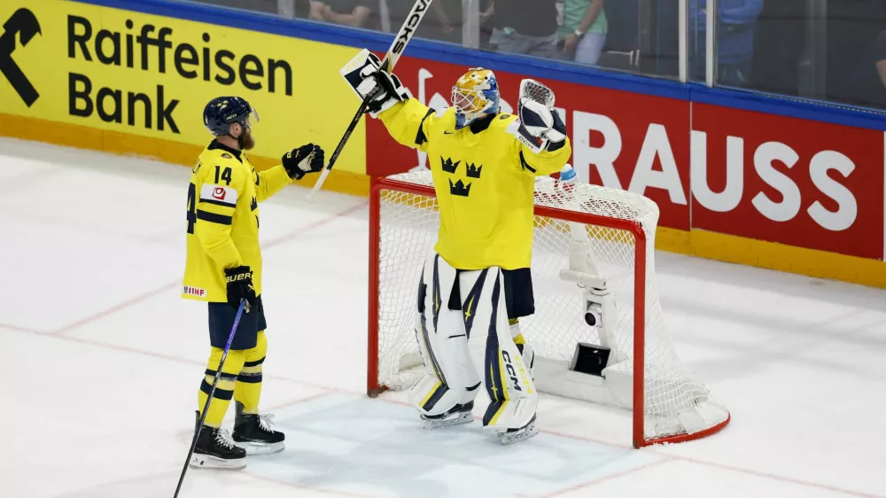 Ice Hockey - IIHF World Championships - Group B - Sweden v Slovakia - BCF Arena, Fribourg, Switzerland - May 26, 2026 Sweden's Magnus Hellberg and Mattias Ekholm celebrate after the match REUTERS/David W Cerny