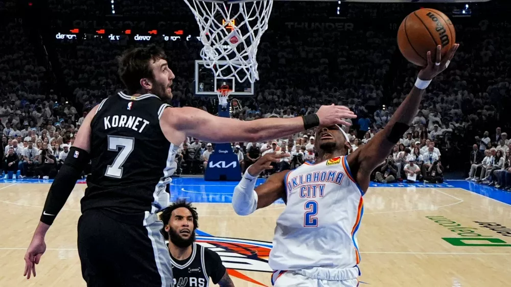 Oklahoma City Thunder guard Shai Gilgeous-Alexander (2) shoots against San Antonio Spurs center Luke Kornet (7) in the second half of Game 5 in the Western Conference finals NBA basketball playoffs series, Tuesday, May 26, 2026, in Oklahoma City. (AP Photo/Julio Cortez)