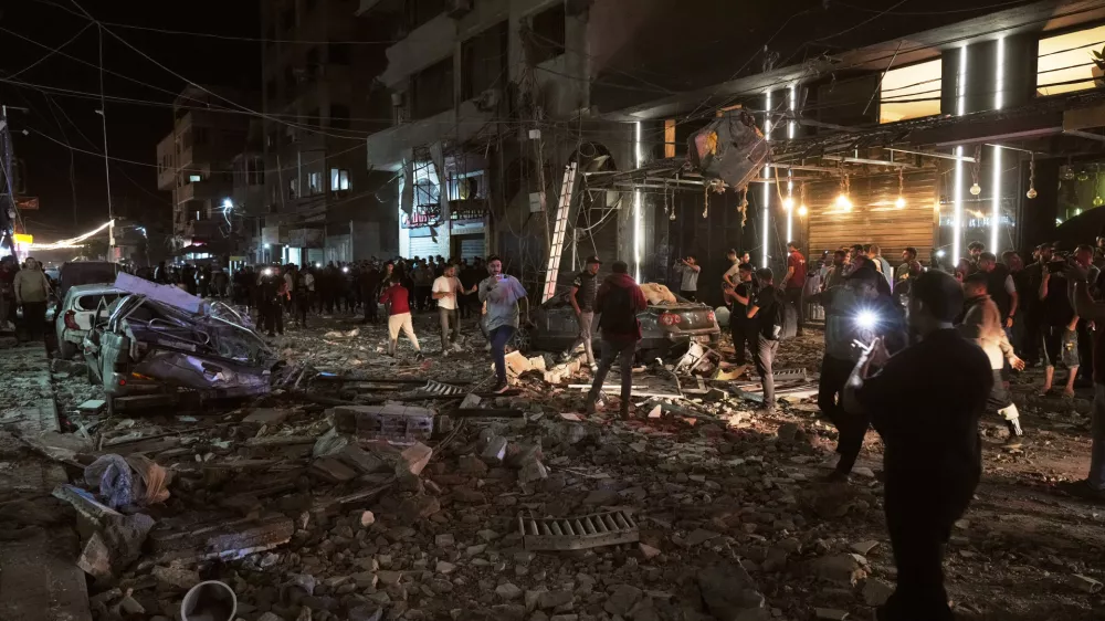 Palestinians inspect the site of an Israeli airstrike in Gaza City Tuesday, May 26, 2026. (AP Photo/Jehad Alshrafi)