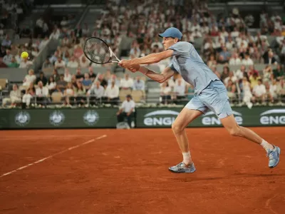 Jannik Sinner of Italy returns to Clement Tabur of France during their first round men's singles tennis match at the French Open tennis tournament in Paris, Tuesday, May 26, 2026. (AP Photo/Thibault Camus)
