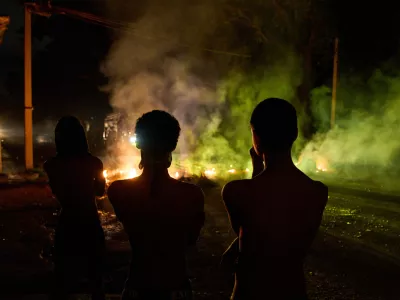 People look at a barricade set up by residents protesting against prolonged power outages in Havana, Cuba, Wednesday, May 13, 2026. (AP Photo/Ramon Espinosa)