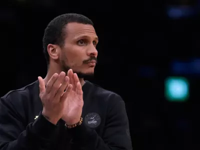 Boston Celtics head coach Joe Mazzulla applauds during the first half of Game 2 of a first-round NBA playoffs basketball series against the Philadelphia 76ers, Tuesday, April 21, 2026, in Boston. (AP Photo/Charles Krupa)