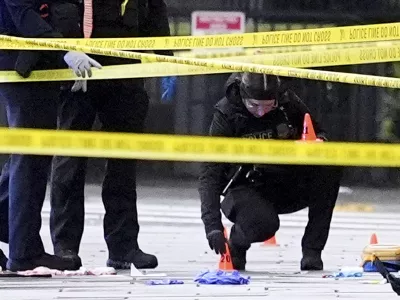 U.S. Secret Service Police place evidence markers on a crime scene after responding to reports of shots fired near the White House, Saturday, May 23, 2026, in Washington. (AP Photo/Alex Brandon)