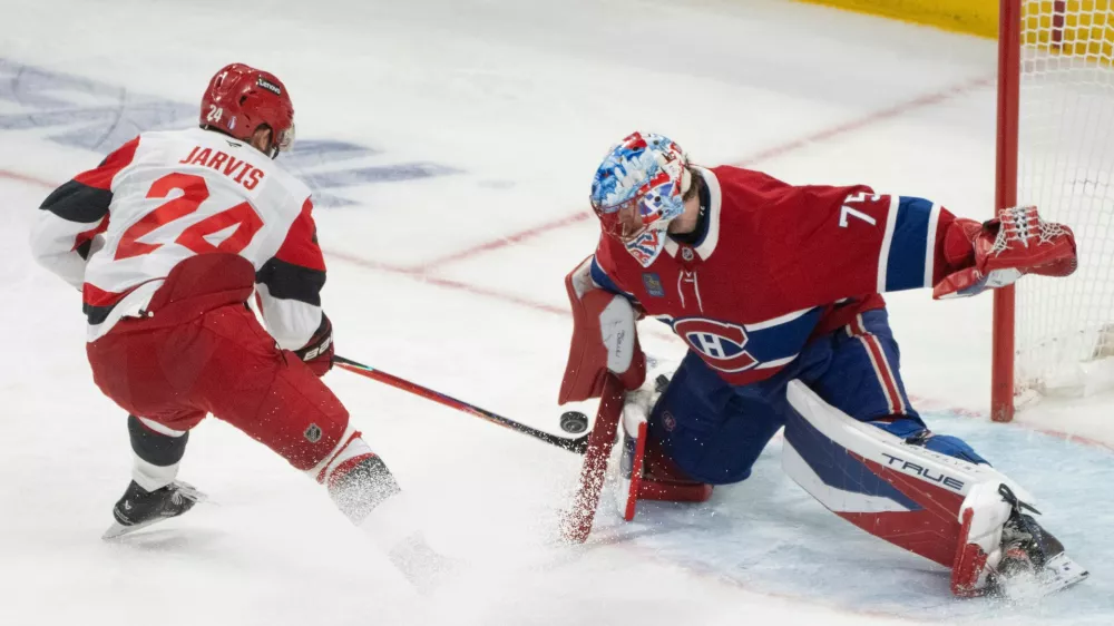 Montreal Canadiens goaltender Jakub Dobes (75) makes a save against Carolina Hurricanes' Seth Jarvis (24) during third period of Game 4 of the NHL Eastern Conference final Stanley Cup playoff series game in Montreal on Wednesday, May 27, 2026. (Christinne Muschi/The Canadian Press via AP)
