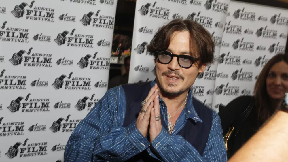 In this handout photo provided by the Austin Film Festival, actor Johnny Depp arrives at a screening of their new film 'The Rum Diary' during the Austin Film Festival and Conference, Friday, Oct 21, 2011, in Austin, Texas.(AP Photo/Austin Film Festival, Jack Plunkett)
