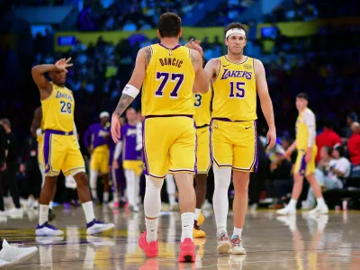 Mar 12, 2026; Los Angeles, California, USA; Los Angeles Lakers guard Luka Doncic (77) and guard Austin Reaves (15) react during the second half at Crypto.com Arena. Mandatory Credit: Gary A. Vasquez-Imagn Images