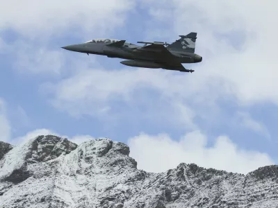 FILE --- In this Oct 11, 2012 file picture a Saab Jas Gripen F Demonstrator jet performs during a flight show of the Swiss air force in Axalp near Meiringen, Switzerland. Swiss voters vote on the purchase of 22 Swedish fighter planes for Switzerland's air force on Sunday, May 18, 2014. (AP Photo/Keystone,Peter Klaunzer)