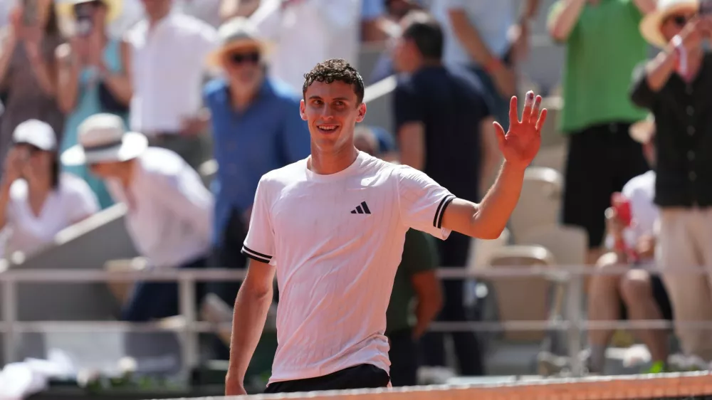 Juan Manuel Cerundolo of Argentina celebrates winning against Jannik Sinner of Italy after their second round men's singles tennis match at the French Open tennis tournament in Paris, Thursday, May 28, 2026. (AP Photo/Thibault Camus)