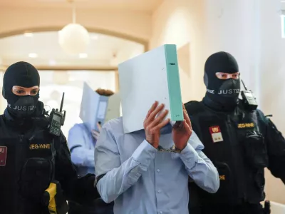 Austrian defendant identified as Beran A, suspected of planning an attack on U.S. singer Taylor Swift's Vienna concert in 2024, is escorted by security personnel in a courtroom for his trial in Wiener Neustadt, Austria, May 28, 2026. REUTERS/Lisa Leutner   TPX IMAGES OF THE DAY