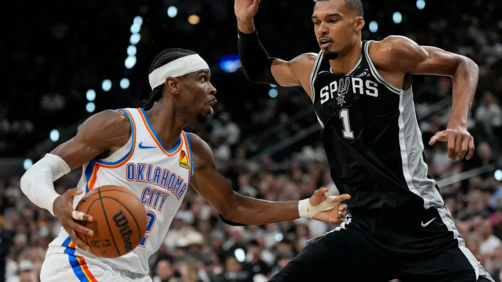 Oklahoma City Thunder guard Shai Gilgeous-Alexander (2) drives against San Antonio Spurs forward Victor Wembanyama (1) in the second half of Game 6 in the Western Conference finals NBA basketball playoffs series, Thursday, May 28, 2026, in San Antonio. (AP Photo/David J. Phillip)