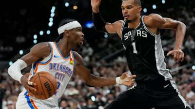 Oklahoma City Thunder guard Shai Gilgeous-Alexander (2) drives against San Antonio Spurs forward Victor Wembanyama (1) in the second half of Game 6 in the Western Conference finals NBA basketball playoffs series, Thursday, May 28, 2026, in San Antonio. (AP Photo/David J. Phillip)