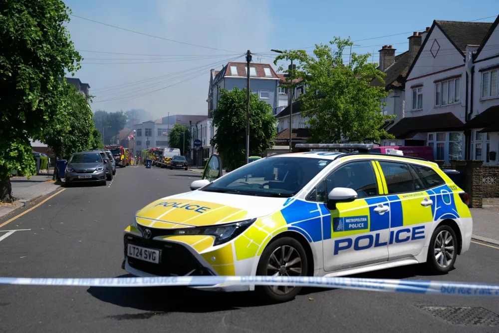 Police officers sit in a police cruiser near the scene of a fire started behind a Jewish supermarket Kosher Kingdom, in the Golders Green area of London, Britain, May 27, 2026. REUTERS/Maja Smiejkowska