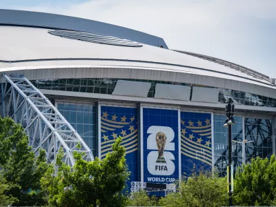 Signage on the exterior of AT&T Stadium, which will be named Dallas Stadium during the 2026 FIFA World Cup, is covered by workers as preparations continue at the venue ahead of the soccer tournament, Thursday, May 28, 2026, Arlington, Texas. (AP Photo/Jessica Tobias)