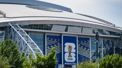 Signage on the exterior of AT&T Stadium, which will be named Dallas Stadium during the 2026 FIFA World Cup, is covered by workers as preparations continue at the venue ahead of the soccer tournament, Thursday, May 28, 2026, Arlington, Texas. (AP Photo/Jessica Tobias)