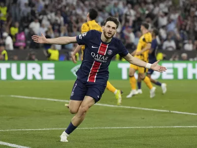 PSG's Khvicha Kvaratskhelia celebrates after scoring his side's fourth goal during the Champions League final soccer match between Paris Saint-Germain and Inter Milan at the Allianz Arena in Munich, Germany, Saturday, May 31, 2025. (AP Photo/Martin Meissner)