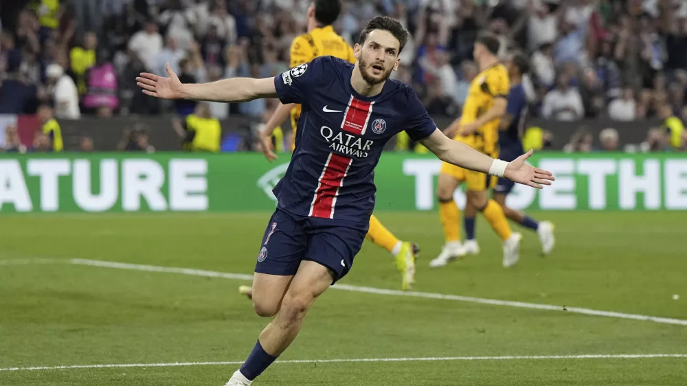 PSG's Khvicha Kvaratskhelia celebrates after scoring his side's fourth goal during the Champions League final soccer match between Paris Saint-Germain and Inter Milan at the Allianz Arena in Munich, Germany, Saturday, May 31, 2025. (AP Photo/Martin Meissner)