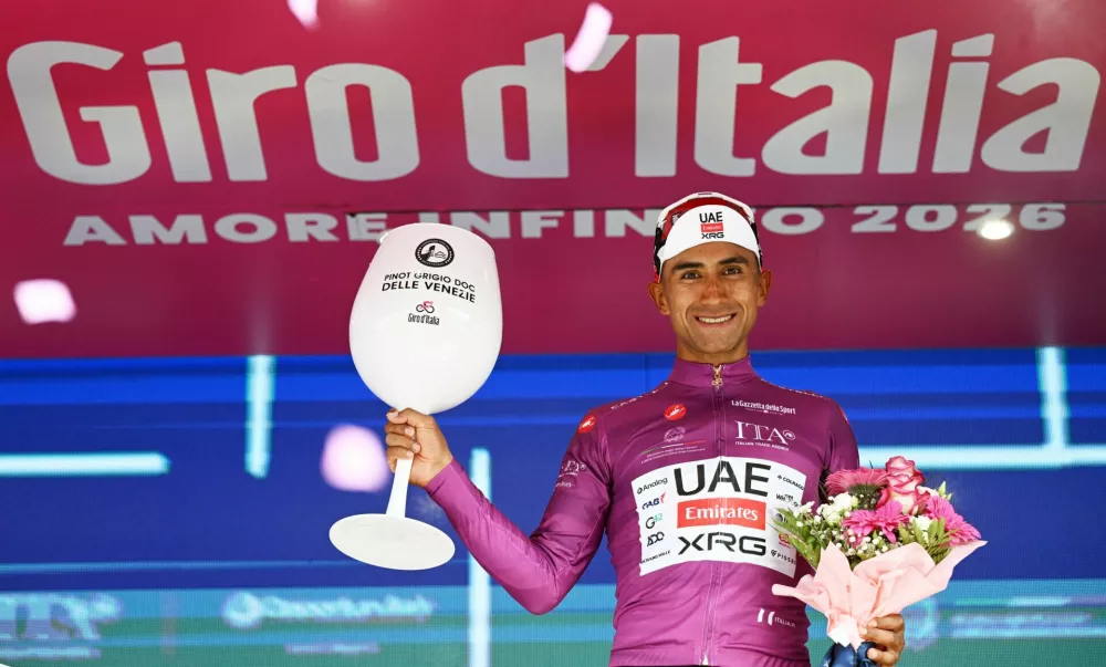 Cycling - Giro d'Italia - Stage 17 - Cassano d'Adda to Andalo - Italy - May 27, 2026 UAE Team Emirates - XRG's Jhonatan Narvaez celebrates wearing the maglia ciclamino jersey after stage 17 REUTERS/Jennifer Lorenzini