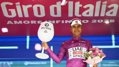 Cycling - Giro d'Italia - Stage 17 - Cassano d'Adda to Andalo - Italy - May 27, 2026 UAE Team Emirates - XRG's Jhonatan Narvaez celebrates wearing the maglia ciclamino jersey after stage 17 REUTERS/Jennifer Lorenzini