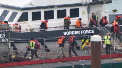 07 August 2025, United Kingdom, Dover: A group of people thought to be migrants are brought in to the Border Force compound in Dover, Kent, from a Border Force vessel following a small boat incident in the Channel. Photo: Gareth Fuller/PA Wire/dpa