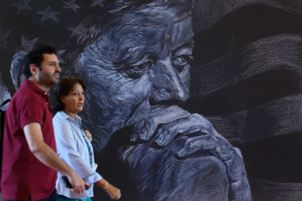 Visitors walk past a portrait of President John F. Kennedy in The John F. Kennedy Center for Performing Arts, in Washington, Friday, May 29, 2026. (AP Photo/Cliff Owen)