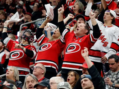 Carolina Hurricanes fans celebrate during the third period in Game 5 of the Eastern Conference finals NHL hockey Stanley Cup playoff series against the Montreal Canadiens in Raleigh, N.C., Friday, May 29, 2026. (AP Photo/Karl DeBlaker)