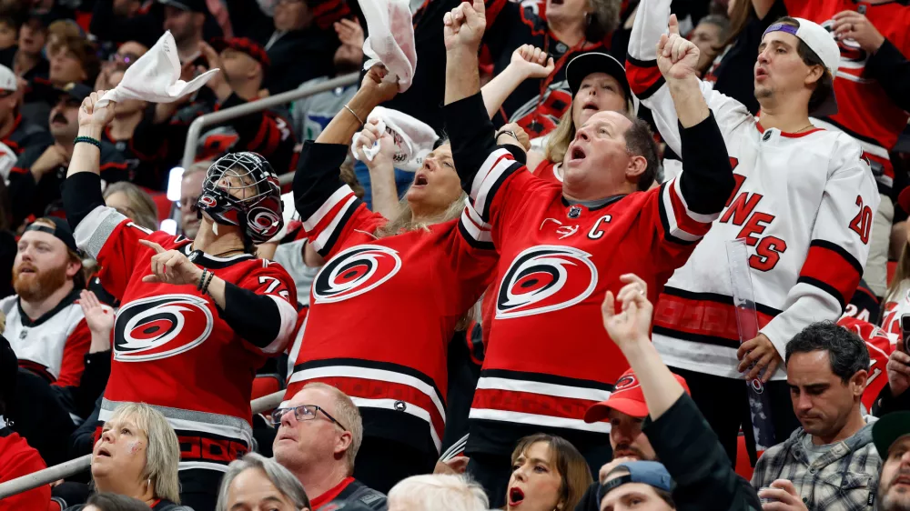 Carolina Hurricanes fans celebrate during the third period in Game 5 of the Eastern Conference finals NHL hockey Stanley Cup playoff series against the Montreal Canadiens in Raleigh, N.C., Friday, May 29, 2026. (AP Photo/Karl DeBlaker)