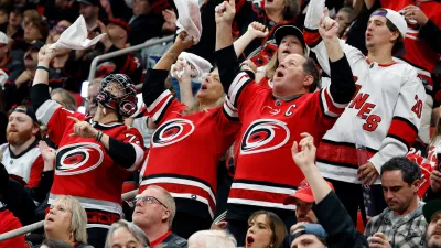 Carolina Hurricanes fans celebrate during the third period in Game 5 of the Eastern Conference finals NHL hockey Stanley Cup playoff series against the Montreal Canadiens in Raleigh, N.C., Friday, May 29, 2026. (AP Photo/Karl DeBlaker)