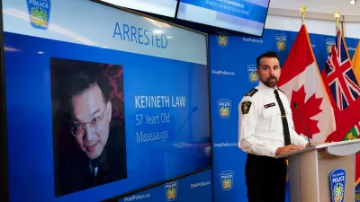 FILE - York Regional Police Inspector Simon James speaks during a news conference in Mississauga, Ont., Aug. 29, 2023, with the image of Kenneth Law, a Canadian man accused of selling lethal substances on the internet to people at risk of self harm, displayed on screen. (Arlyn McAdorey/The Canadian Press via AP, File)
