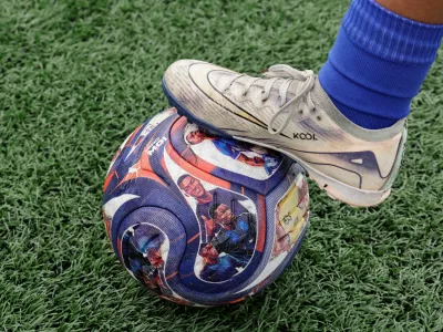 A player places a foot on a soccer ball with images of Ecuadorean soccer player Moises Caicedo that is used during practice at a Nino Moi 23 academy, a project led by Caicedo that focuses on bringing soccer to children in vulnerable communities, in the Guamani neighborhood, in Quito, Ecuador May 18, 2026. REUTERS/Karen Toro