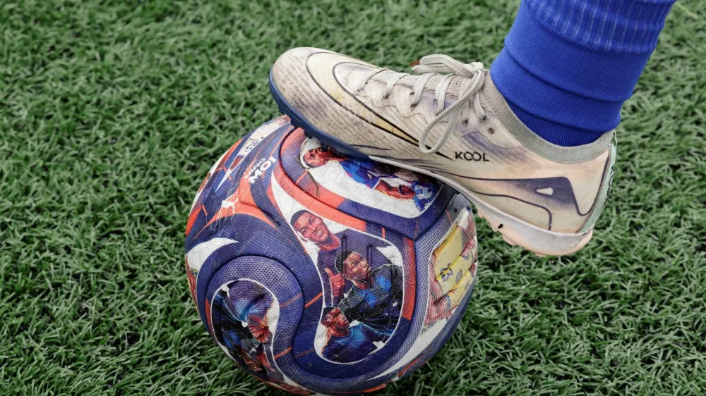 A player places a foot on a soccer ball with images of Ecuadorean soccer player Moises Caicedo that is used during practice at a Nino Moi 23 academy, a project led by Caicedo that focuses on bringing soccer to children in vulnerable communities, in the Guamani neighborhood, in Quito, Ecuador May 18, 2026. REUTERS/Karen Toro