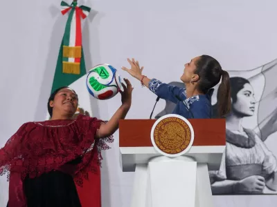 Yolett Cervantes Cuaquehua plays with a ball alongside Mexican President Claudia Sheinbaum after receiving a ticket from her for the opening match of the 2026 World Cup, the June 11 Mexico&ndash;South Africa game at Ciudad de Mexico Stadium, during Sheinbaum's morning press conference at the National Palace in Mexico City, Mexico, May 29, 2026. REUTERS/Quetzalli Nicte-Ha   TPX IMAGES OF THE DAY