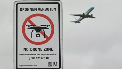 FILE PHOTO: A sign with a drone ban is displayed outside the airport in Munich, Germany October 6, 2025. REUTERS/Angelika Warmuth/File Photo