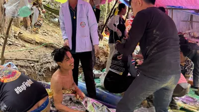 This image provided by the Association Of Volunteers For Lao People, shows rescuers after they safely evacuated the villagers, who had been trapped in a cave in Xaisomboun province, Laos, Saturday, May 30, 2026. (Association Of Volunteers For Lao People via AP)