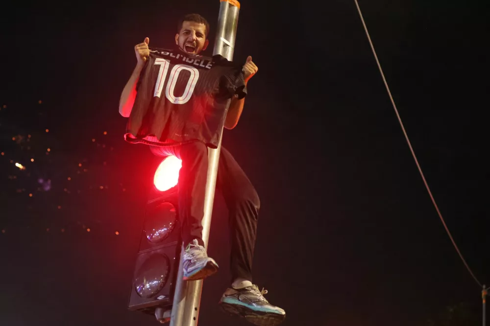 PSG supporters celebrate in Paris, Saturday, May 30, 2026 after the Champions League final soccer match between Paris Saint-Germain and Arsenal that was played in Budapest, PSG won the game. (AP Photo/Thomas Padilla)