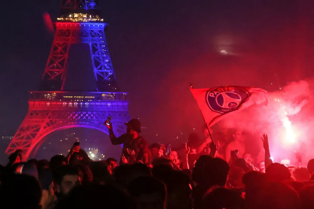 PSG supporters celebrate in Paris, Saturday, May 30, 2026 after the Champions League final soccer match between Paris Saint-Germain and Arsenal that's being played in Budapest, PSG won the match. (AP Photo/Thomas Padilla)