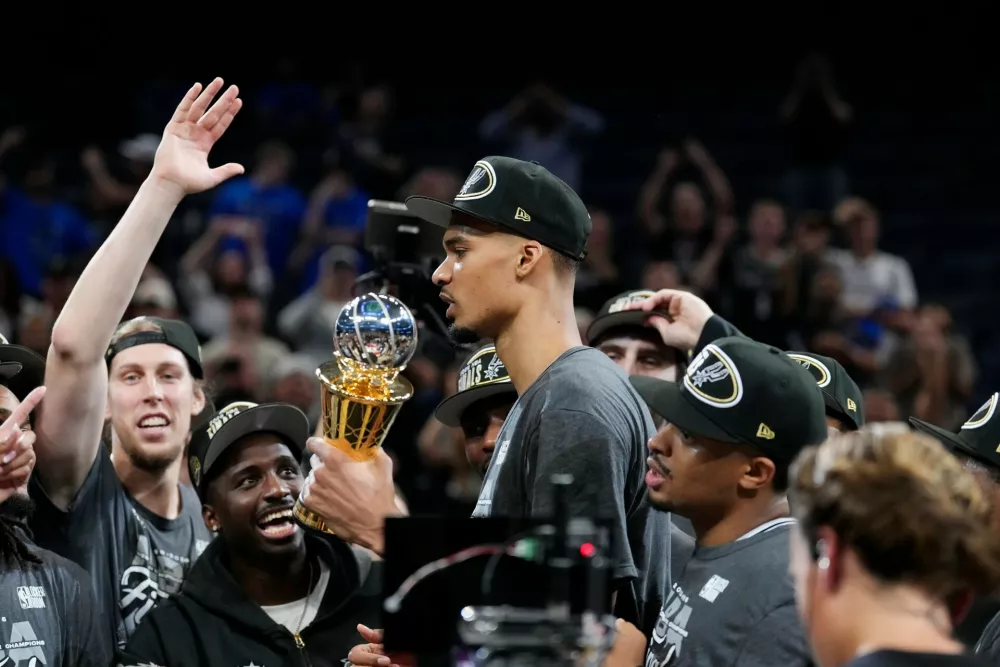 San Antonio Spurs forward Victor Wembanyama holds the MVP trophy as he celebrates with teammates after Game 7 of the Western Conference finals of the NBA basketball playoffs series win against the Oklahoma City Thunder, Saturday, May 30, 2026, in Oklahoma City. (AP Photo/Tony Gutierrez)