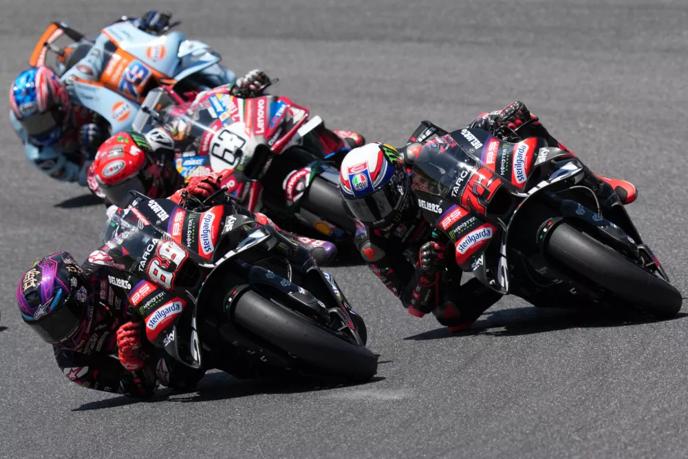 Spain's rider Jorge Martin of the Aprilia Racing, left, steers his motorcycle followed by Italian rider Marco Bezzecchi of the Aprilia Racing during the MotoGP race of the Grand Prix of Italy at the Mugello circuit in Scarperia, Italy, Sunday, May 31, 2026. (AP Photo/Antonio Calanni)