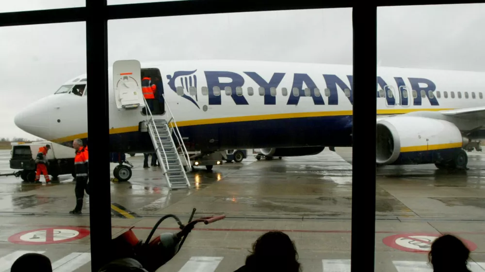 FILE PHOTO: Travellers wait in front of a passenger jet belonging to Irish discount airline Ryanair at Charleroi airport in southern Belgium, February 2, 2004. REUTERS/Yves Herman/File Photo     GLOBAL BUSINESS WEEK AHEAD   SEARCH GLOBAL BUSINESS 24 JUL FOR ALL IMAGES
