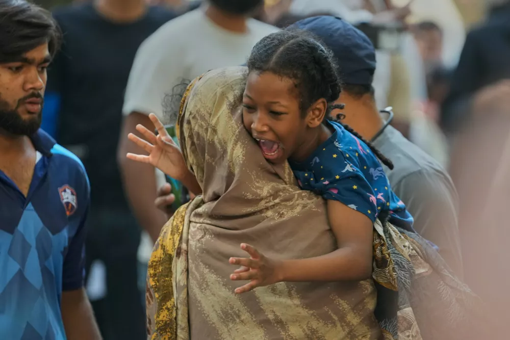 A girl reacts after being rescued from a hotel fire in New Delhi, India, Wednesday, June 3, 2026. (AP Photo/Manish Swarup)