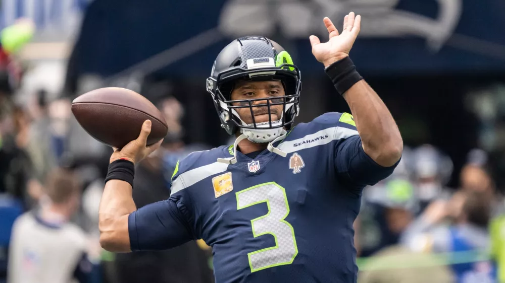 FILE - Seattle Seahawks quarterback Russell Wilson passes the ball during warmups before an NFL football game against the Arizona Cardinals, Nov. 21, 2021, in Seattle. (AP Photo/Stephen Brashear, File)