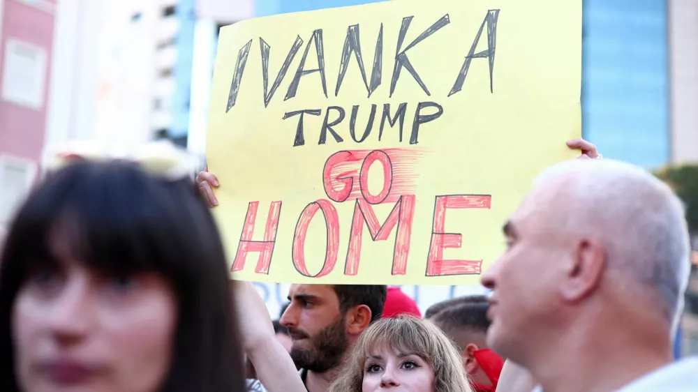 A demonstrator holds a banner as they protest against a luxury resort, a plan by a company linked with Donald Trump's son-in-law Jared Kushner, in a protected area, in Tirana, Albania, June 2, 2026. REUTERS/Florion Goga
