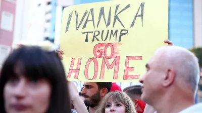 A demonstrator holds a banner as they protest against a luxury resort, a plan by a company linked with Donald Trump's son-in-law Jared Kushner, in a protected area, in Tirana, Albania, June 2, 2026. REUTERS/Florion Goga